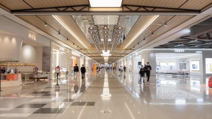 a group of people walking down a long hallway