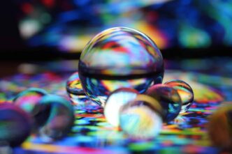 clear glass ball on blue and white textile