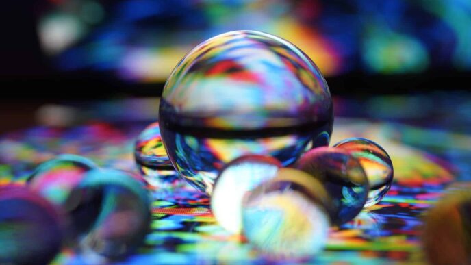 clear glass ball on blue and white textile