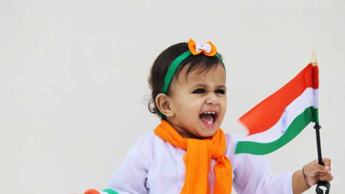 girl in white and green long sleeve shirt with orange and white scarf